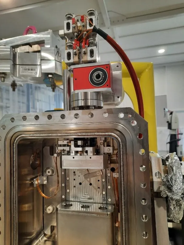 The insides of a tank, showing the interferometer heads (bottom), rotational stage (middle) and crystal mount (top)