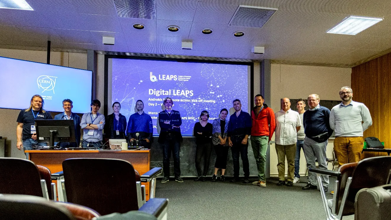 A group of people standing in front of a screen

Description automatically generated